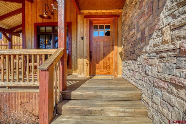 entrance to property featuring stone siding