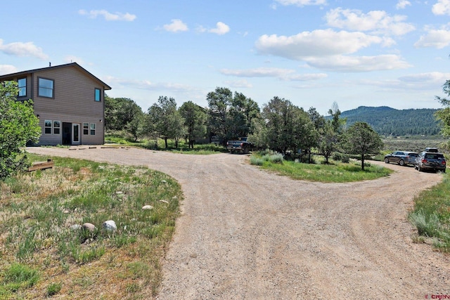 view of street with driveway and a mountain view