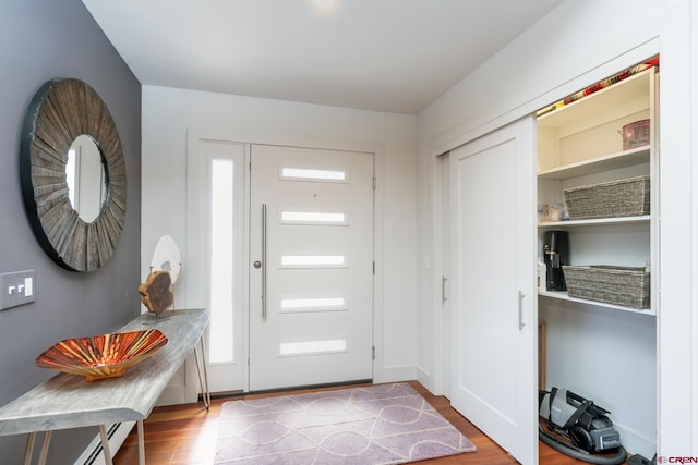 entryway featuring wood finished floors and baseboards