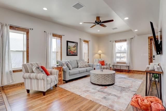 living area with a healthy amount of sunlight, recessed lighting, visible vents, and light wood-style floors