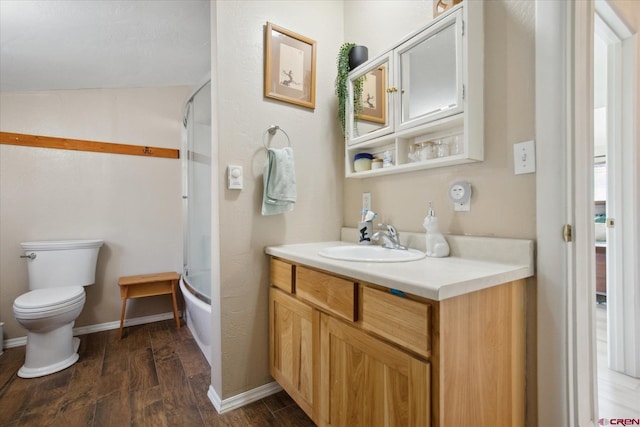 full bathroom featuring enclosed tub / shower combo, toilet, wood finished floors, vanity, and baseboards