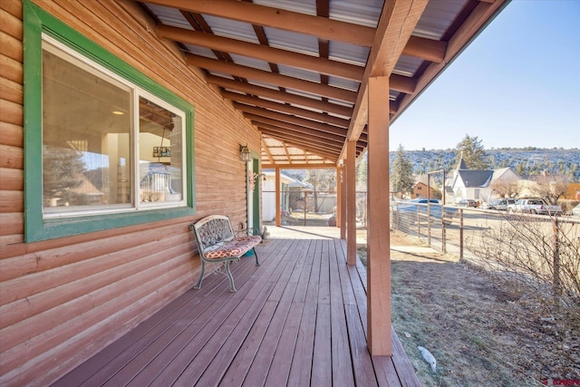 deck with a residential view and fence