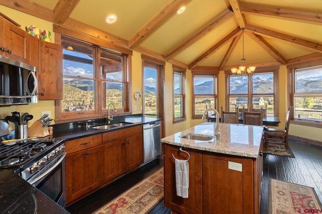 kitchen featuring a sink, a notable chandelier, vaulted ceiling with beams, and appliances with stainless steel finishes