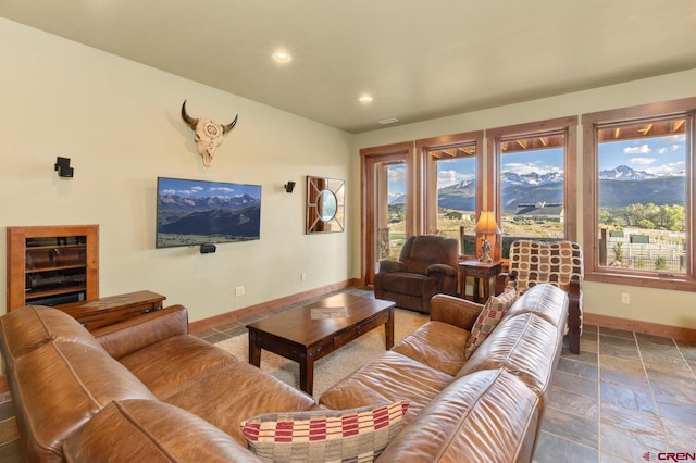 living area featuring baseboards, recessed lighting, and stone tile flooring