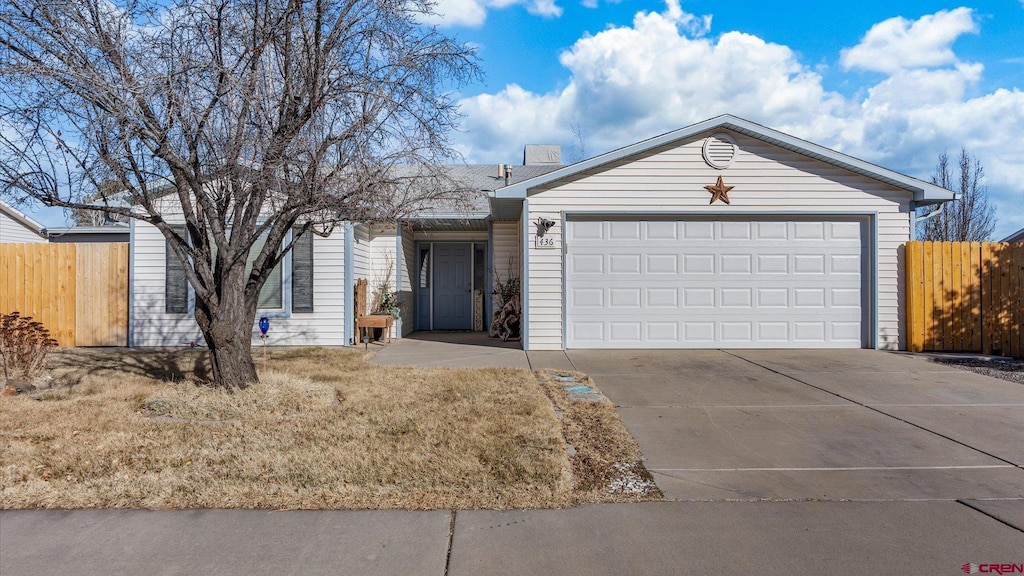 single story home with a garage, driveway, and fence