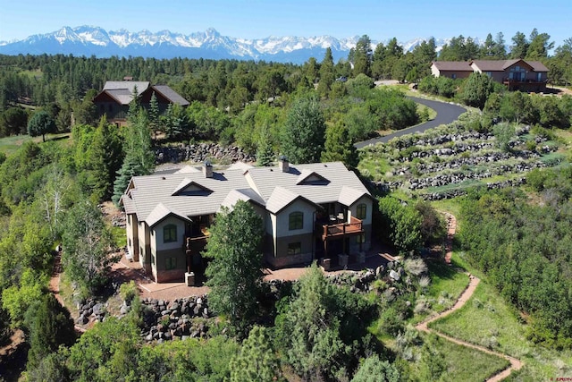 aerial view with a mountain view and a view of trees