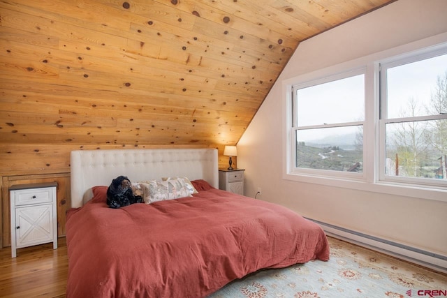 bedroom with wooden ceiling, vaulted ceiling, baseboard heating, and wood finished floors