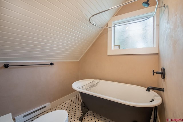 bathroom featuring a baseboard heating unit, lofted ceiling, and a freestanding bath