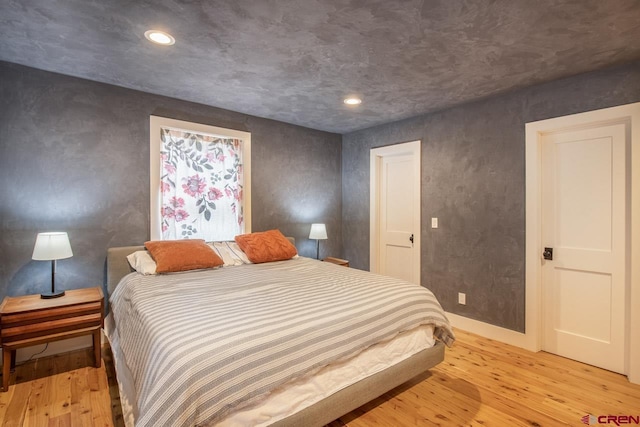 bedroom featuring light wood finished floors and recessed lighting