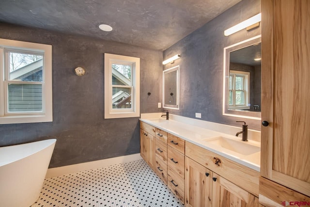 full bath with a soaking tub, a sink, and double vanity