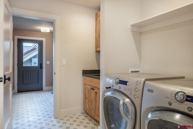 clothes washing area featuring light floors, baseboards, cabinet space, and washing machine and clothes dryer