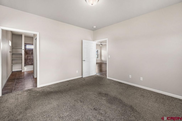 unfurnished bedroom featuring carpet and baseboards