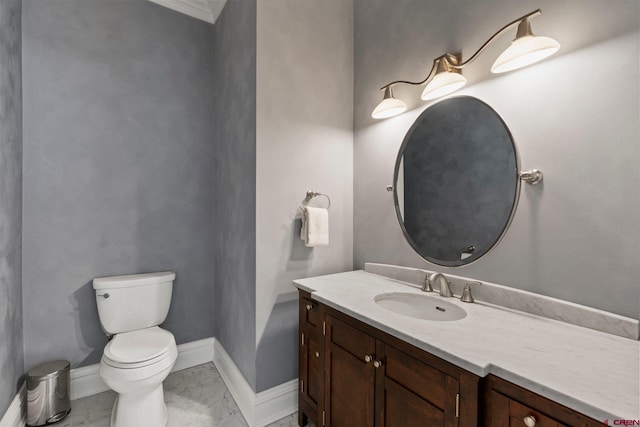 bathroom featuring marble finish floor, baseboards, vanity, and toilet