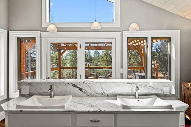 interior space featuring plenty of natural light, vaulted ceiling, and a sink