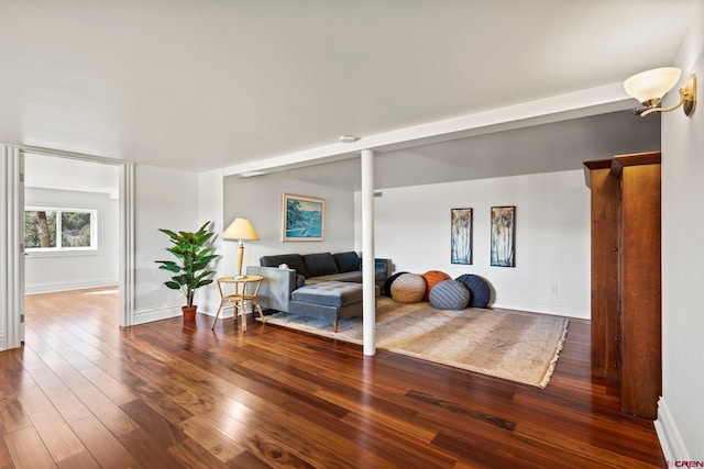 living room with wood-type flooring and baseboards