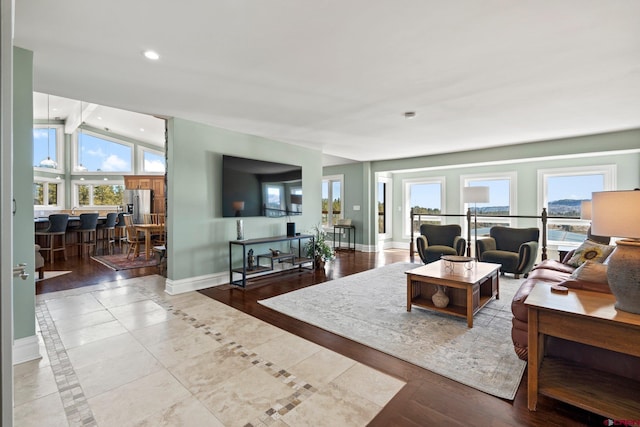 living room with vaulted ceiling with beams, baseboards, a wealth of natural light, and recessed lighting