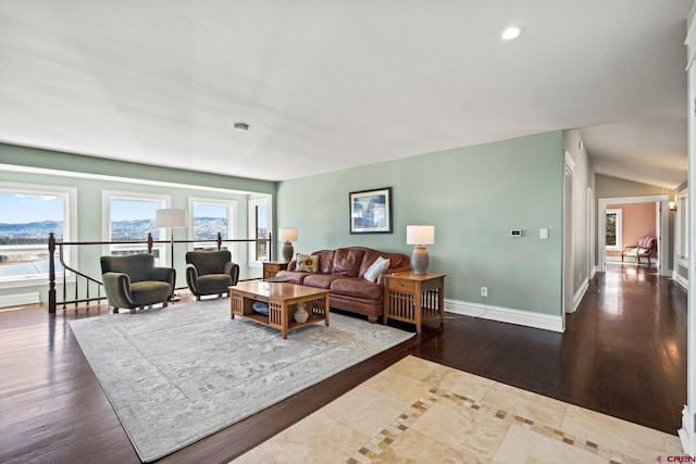 living area with baseboards, vaulted ceiling, wood finished floors, and recessed lighting