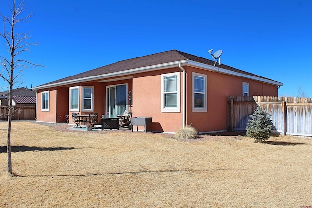 back of property featuring a patio, fence, and stucco siding