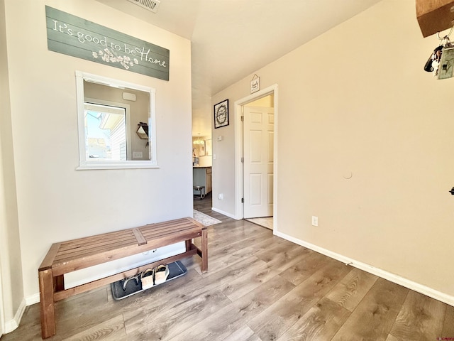 interior space with baseboards and wood finished floors