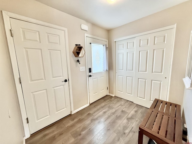 interior space featuring baseboards and light wood-style floors