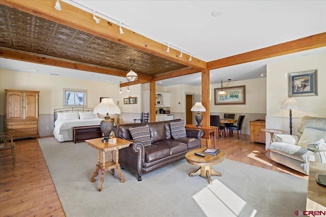 living area featuring wainscoting and wood finished floors