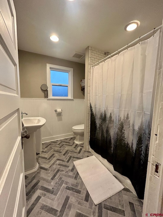 full bath with recessed lighting, curtained shower, visible vents, toilet, and wainscoting