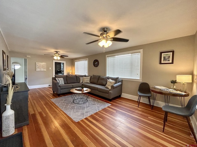 living room with ceiling fan, wood-type flooring, and baseboards