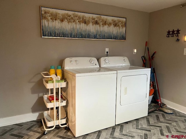 laundry room with laundry area, baseboards, and washer and dryer