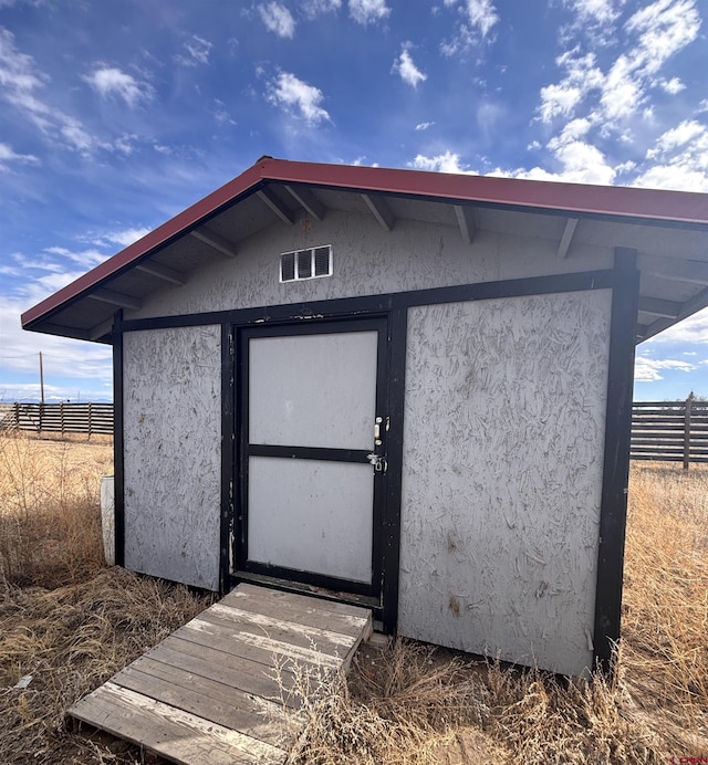 view of shed featuring fence