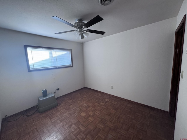 spare room featuring visible vents and a ceiling fan