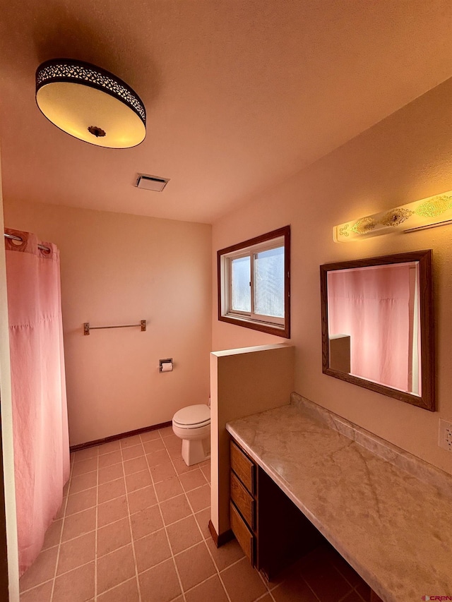 bathroom with baseboards, visible vents, toilet, a shower with curtain, and tile patterned floors