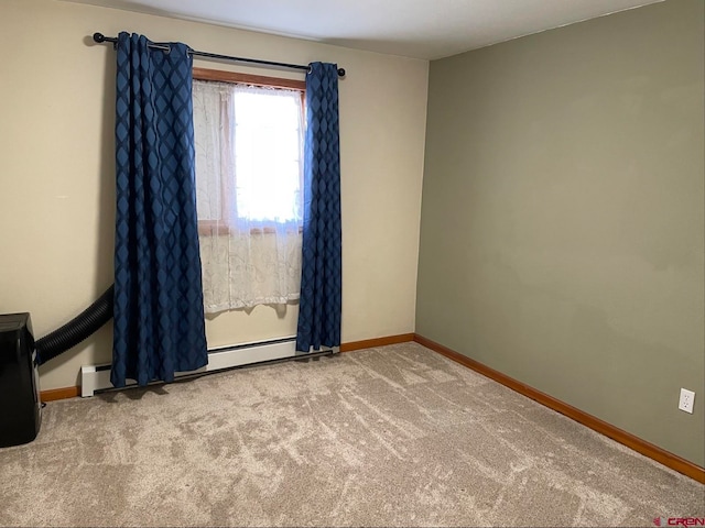 carpeted empty room with a baseboard heating unit, a baseboard radiator, and baseboards