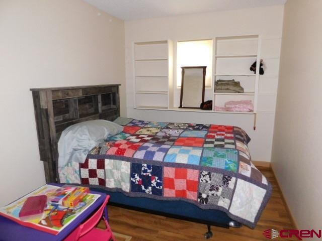 bedroom with wood finished floors