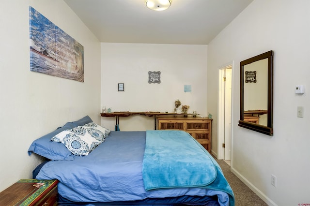 carpeted bedroom featuring baseboards