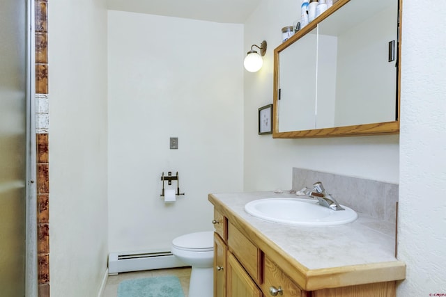 bathroom featuring baseboard heating, vanity, toilet, and tile patterned floors