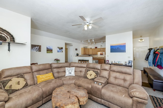 carpeted living area featuring ceiling fan