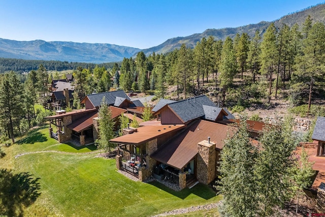 aerial view with a mountain view and a wooded view