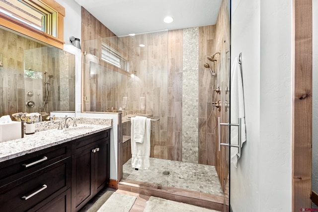 full bathroom with walk in shower and vanity