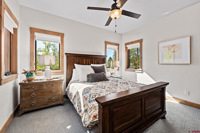 bedroom with a ceiling fan, baseboards, and carpet flooring