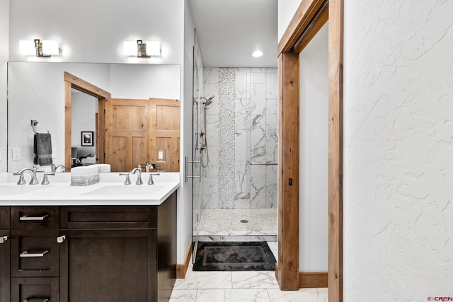 full bathroom featuring marble finish floor, a sink, and a marble finish shower