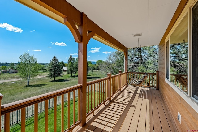 deck featuring visible vents and a lawn