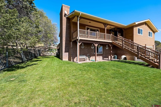 rear view of house featuring brick siding, a patio, a chimney, a lawn, and fence