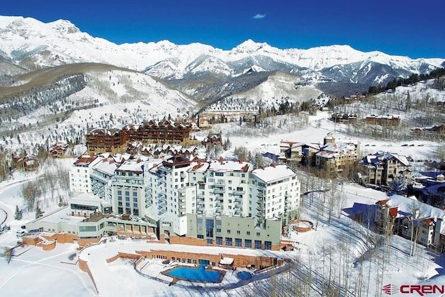 snowy aerial view with a mountain view