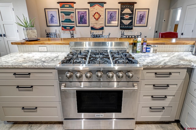 kitchen featuring butcher block counters and stainless steel stove