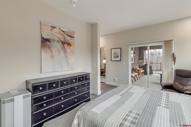 bedroom with carpet floors, access to outside, and baseboards