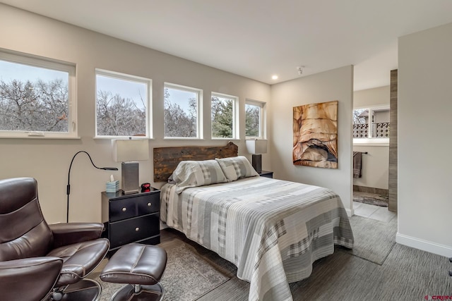 bedroom with ensuite bathroom, recessed lighting, and baseboards