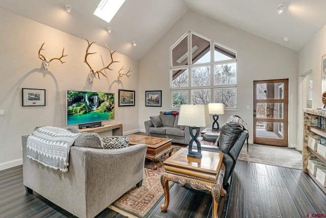 living room featuring high vaulted ceiling, a skylight, wood finished floors, and baseboards