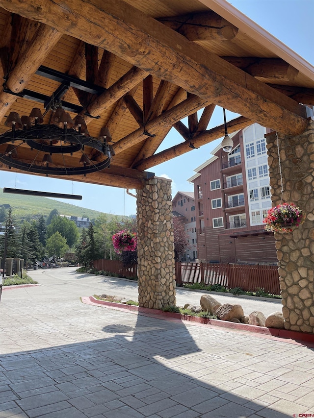 view of patio featuring fence and a gazebo