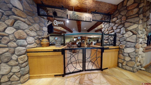 bar featuring wet bar and beam ceiling