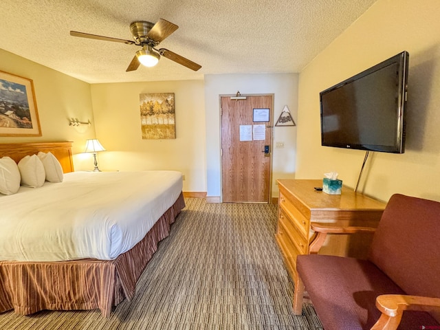 bedroom featuring carpet, baseboards, ceiling fan, and a textured ceiling